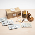 Coffret Aromafume Spiritual Awareness avec brûleur fleur de vie posé sur un meuble en bois